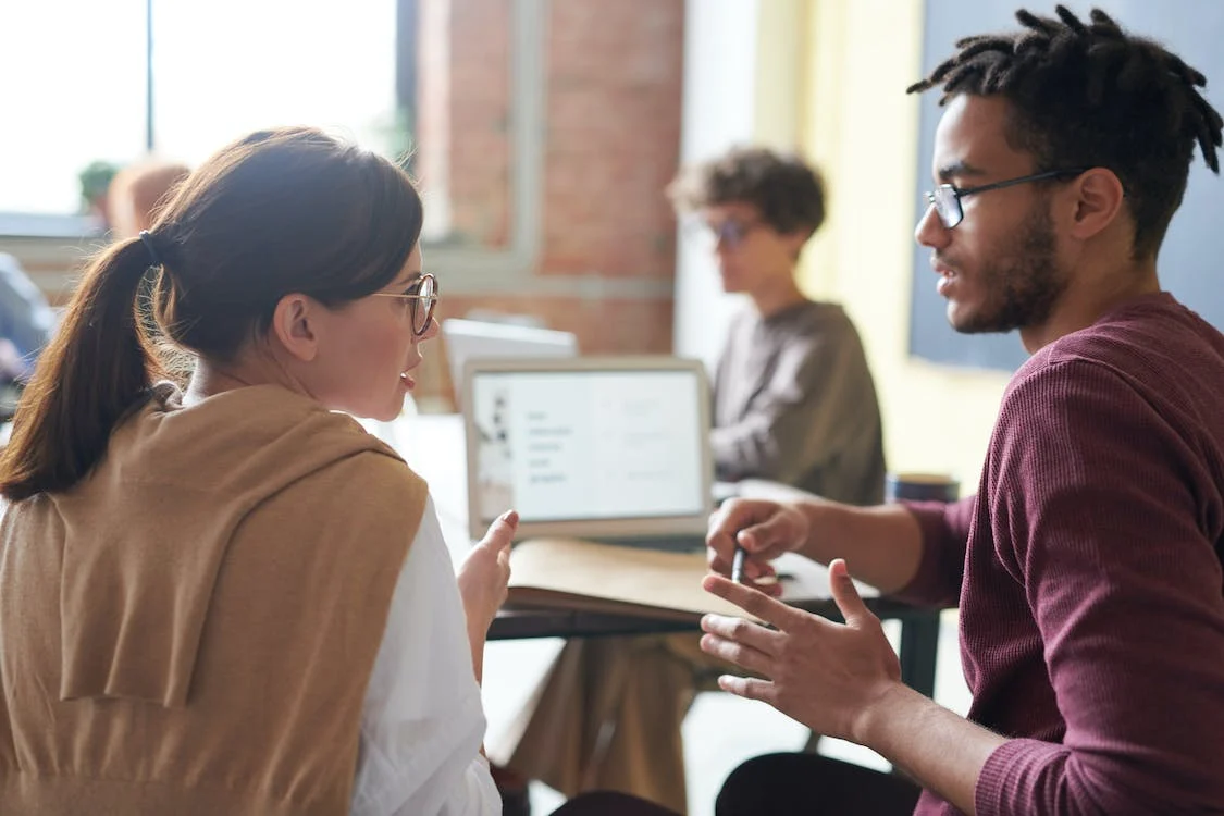 Two people talking about the project